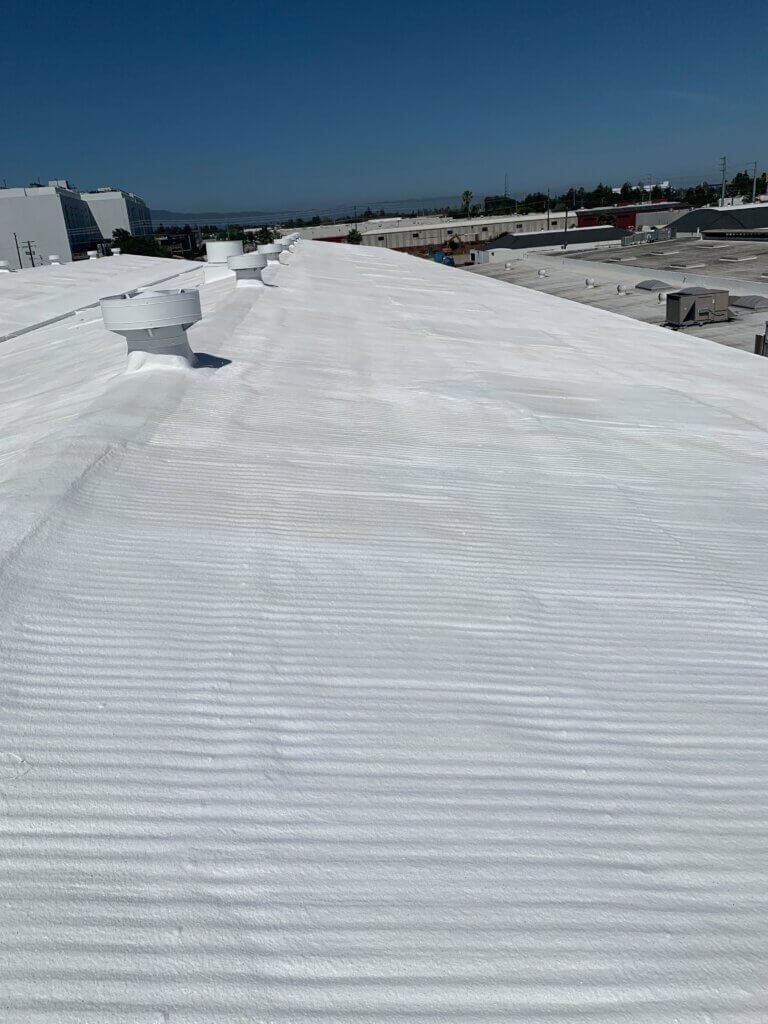 Camino Storage facility in Santa Clara showing the freshly coated white spray foam roof gleaming under the California sun