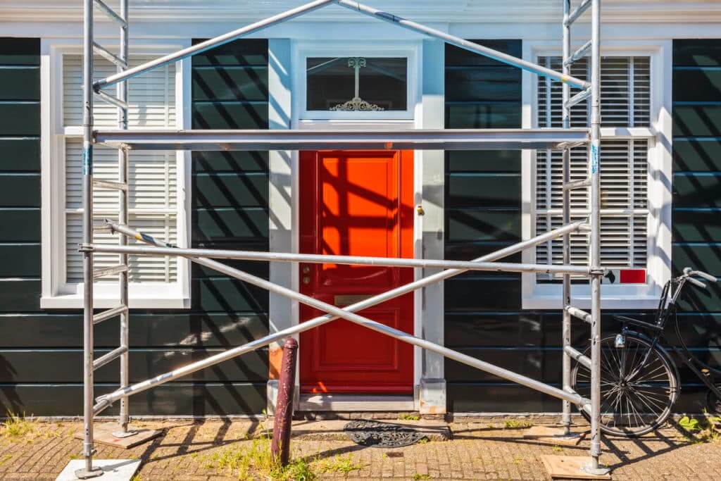 Armstrong Painting - Exterior Painting of forest green home with scaffolds in front of entry